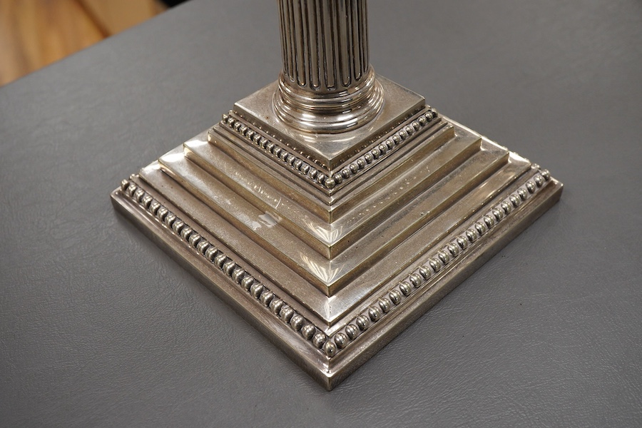 A garniture of 19th century silver plated Corinthian column candelabra, comprising a pair of two branch, three light candelabra and matching four branch, five light candelabrum, with detachable acanthus leaf capped scrol